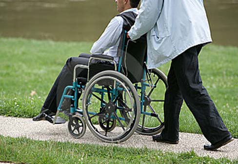 person-pushing-disabled-person-17039782